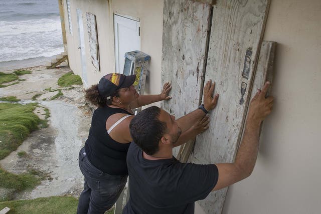 Puerto Rico residents board up their home ahead of Storm Dorian's arrival