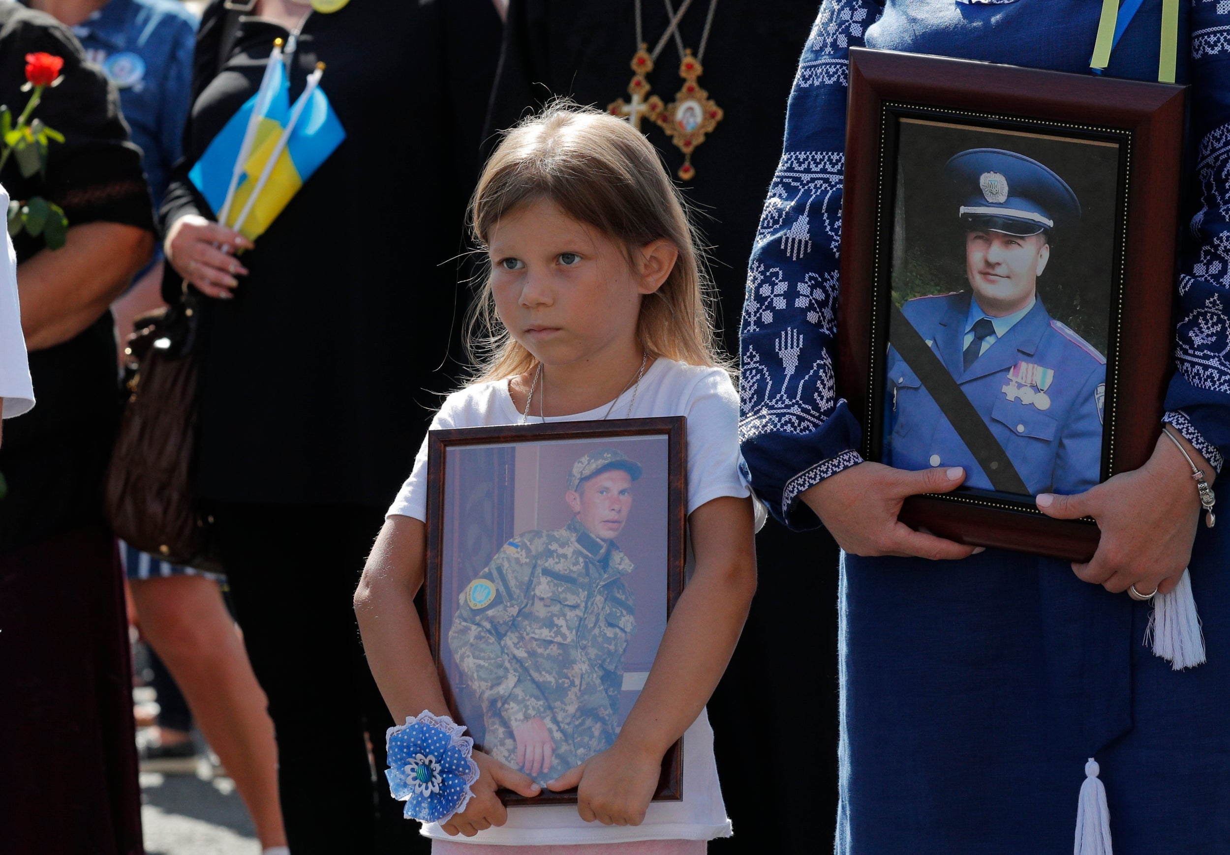 Relatives carry pictures of Ukrainian soldiers killed fighting Russia-backed separatist militias in the east of the country