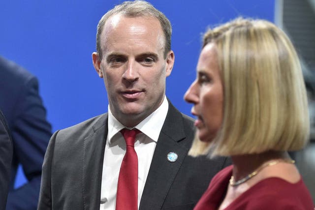 British Foreign Secretary and First Secretary of State Dominic Raab and European Union Foreign Policy Chief Federica Mogherini arrive for the family photo at the Informal Meeting of the EU Foreign Ministers in Helsinki, Finland