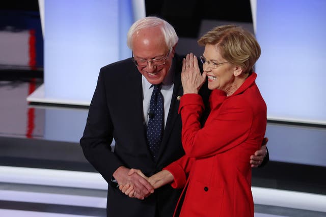 Democratic presidential candidate Bernie Sanders and Elizabeth Warren greet each other at the start of the Democratic Presidential Debate in July