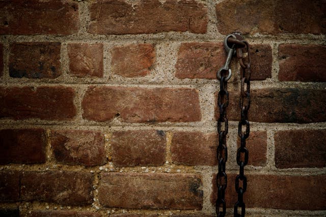 Chains and a lock attached to a wall at Mount Vernon estate, home to George Washington, first president of the United States and a slave owner