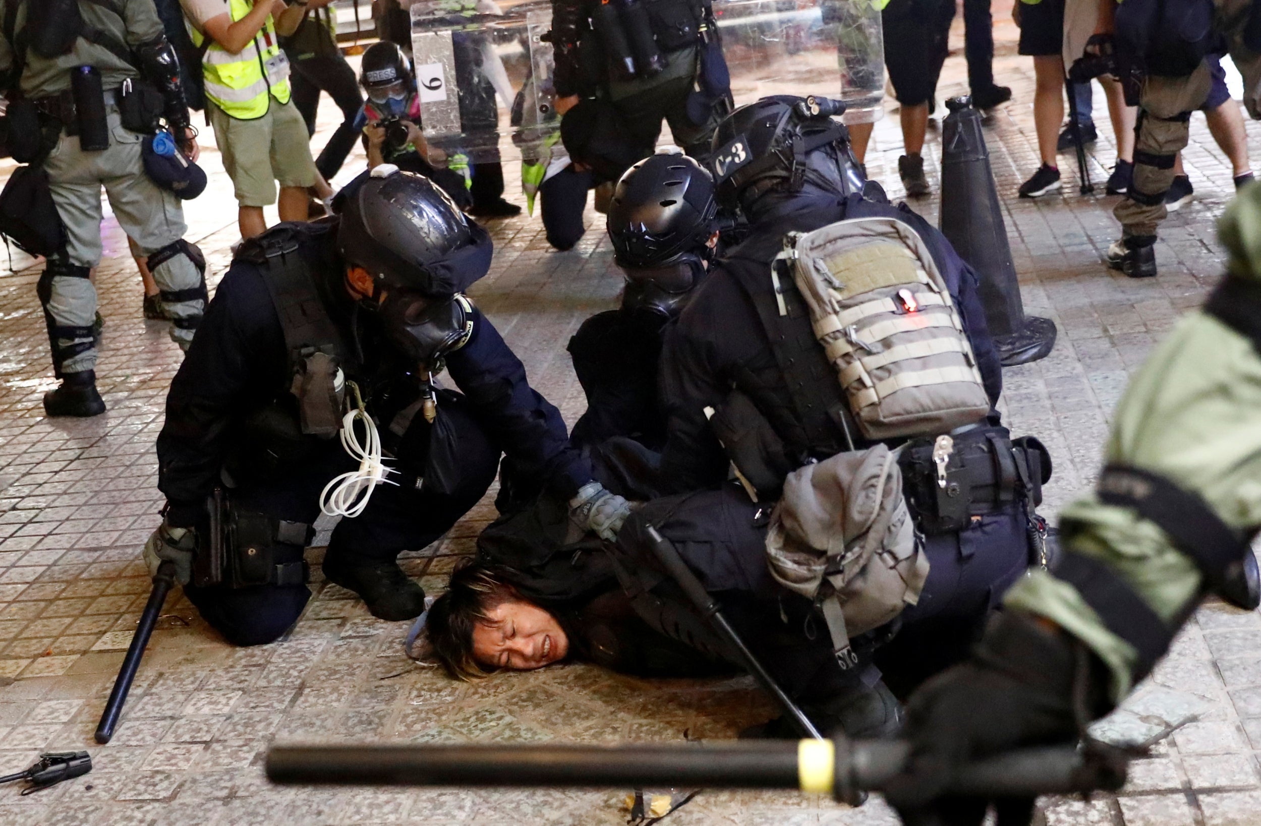 A demonstrator is detained by police officers during a protest in Hong Kong (Reuters)