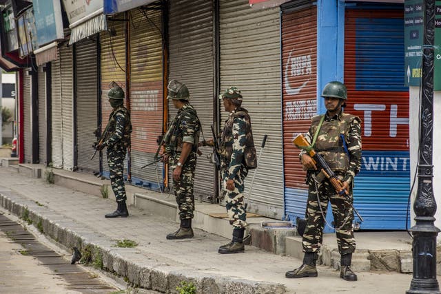 Indian paramilitary forces stand guard in central Srinagar on Friday