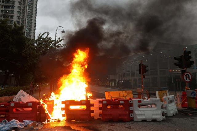 Protesters set barricades on fire near the Tung Chung MTR station in Hong Kong