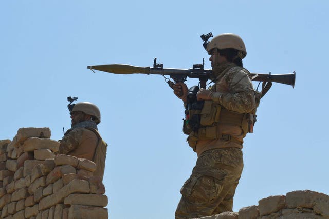 Afghan security forces take position during a battle with the Taliban in Kunduz province, Afghanistan