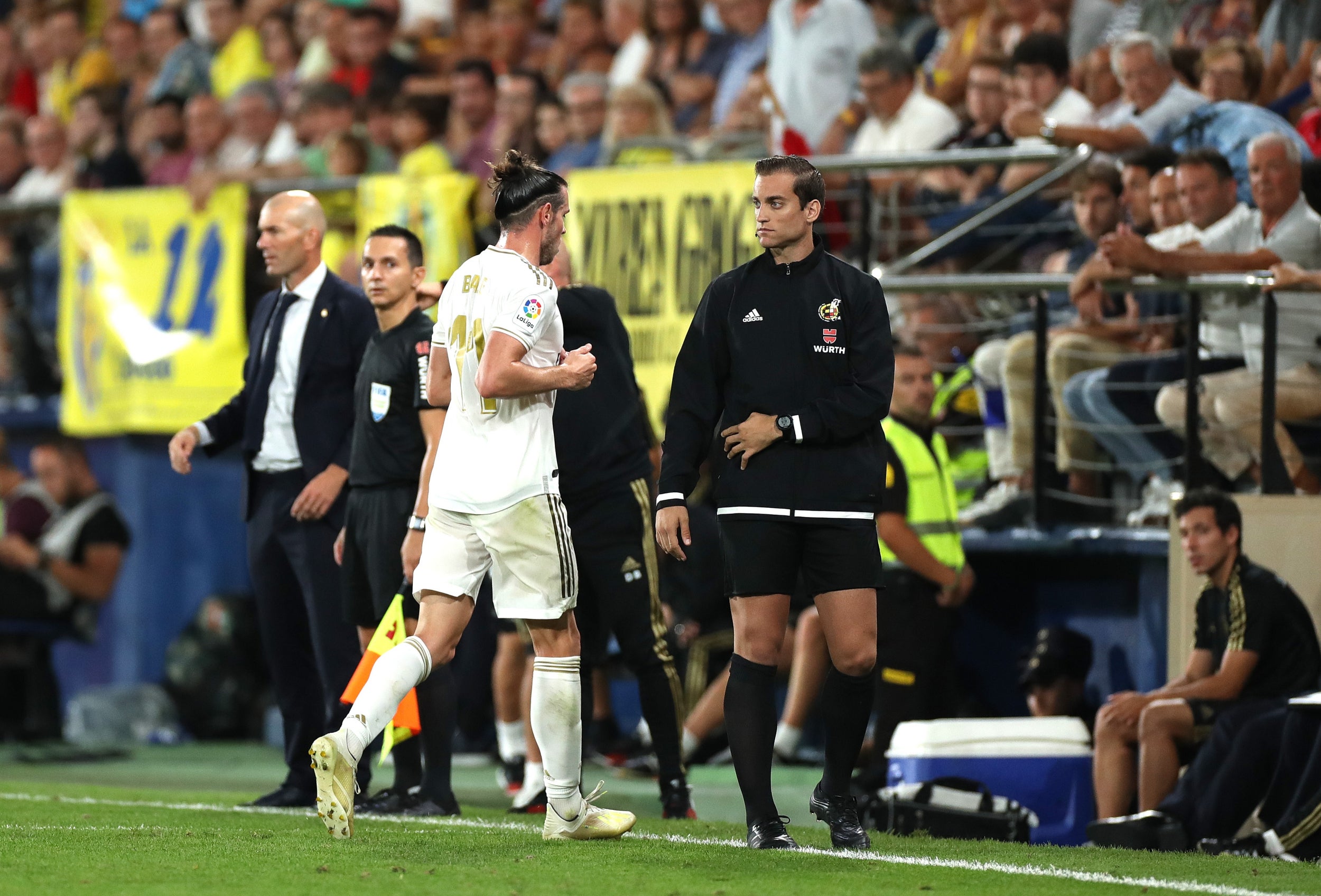 Bale leaves the field after receiving a red card (Getty)