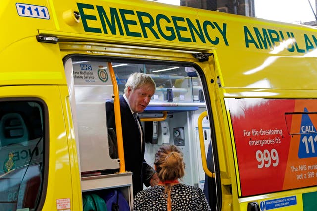 Boris Johnson inspects an ambulance during a visit to Pilgrim Hospital in Boston after promising new funding for the NHS in August