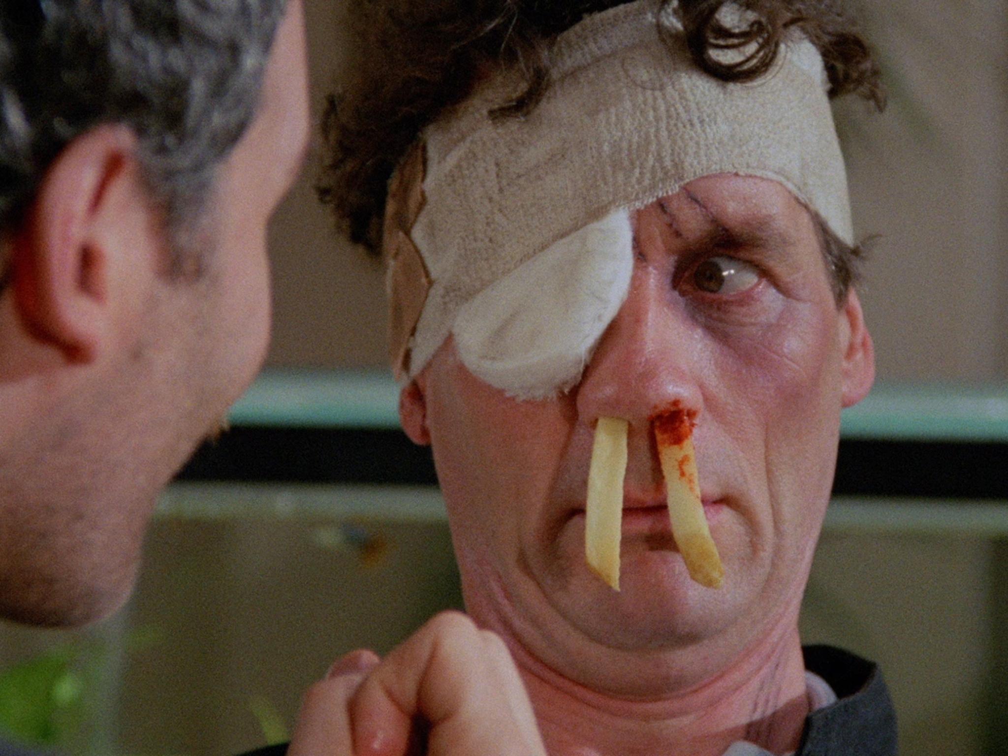 Fist and chips: Otto (Kevin Kline) tortures Ken (Michael Palin) in creative fashion