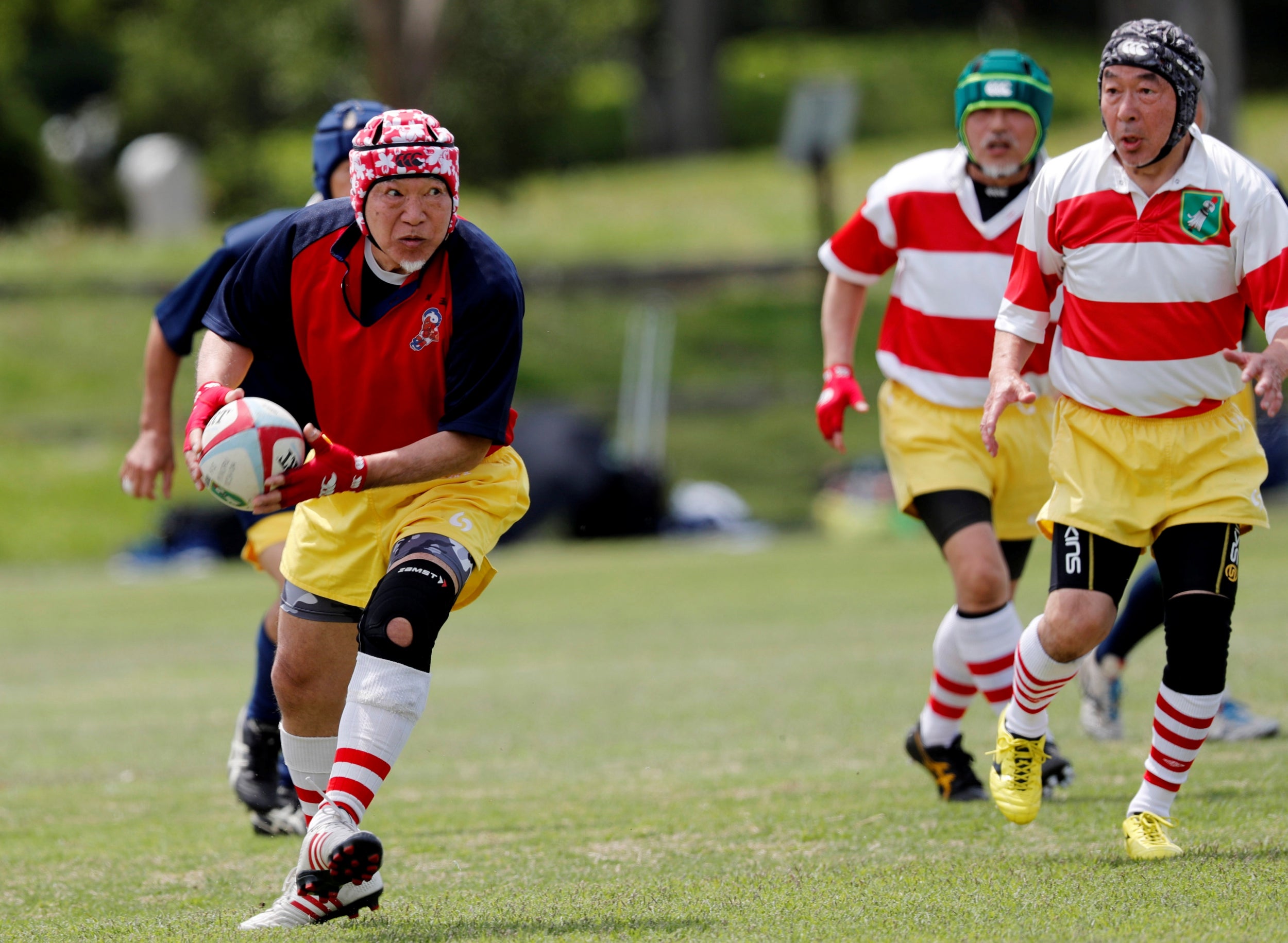 Katsuhiko Maruyama (R), a Fuwaku Rugby Club player, participates in a friendly match in Fukaya. Fuwaku, founded in 1948, is one of approximately 150 Japanese clubs that stage competitive, full-contact matches for players over the age of 40.