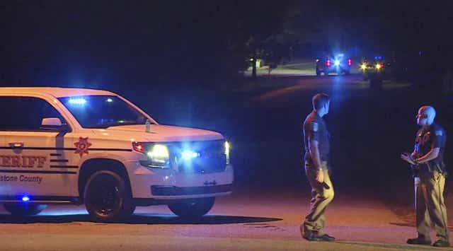 In this photo provided by WHNT-TV News, authorities block access to a street, in Elkmont, Ala., Tuesday, Sept. 3, 2019. Authorities in Elkmont say a teenager called 911 about hearing gunshots and then admitted to killing multiple members of his family.