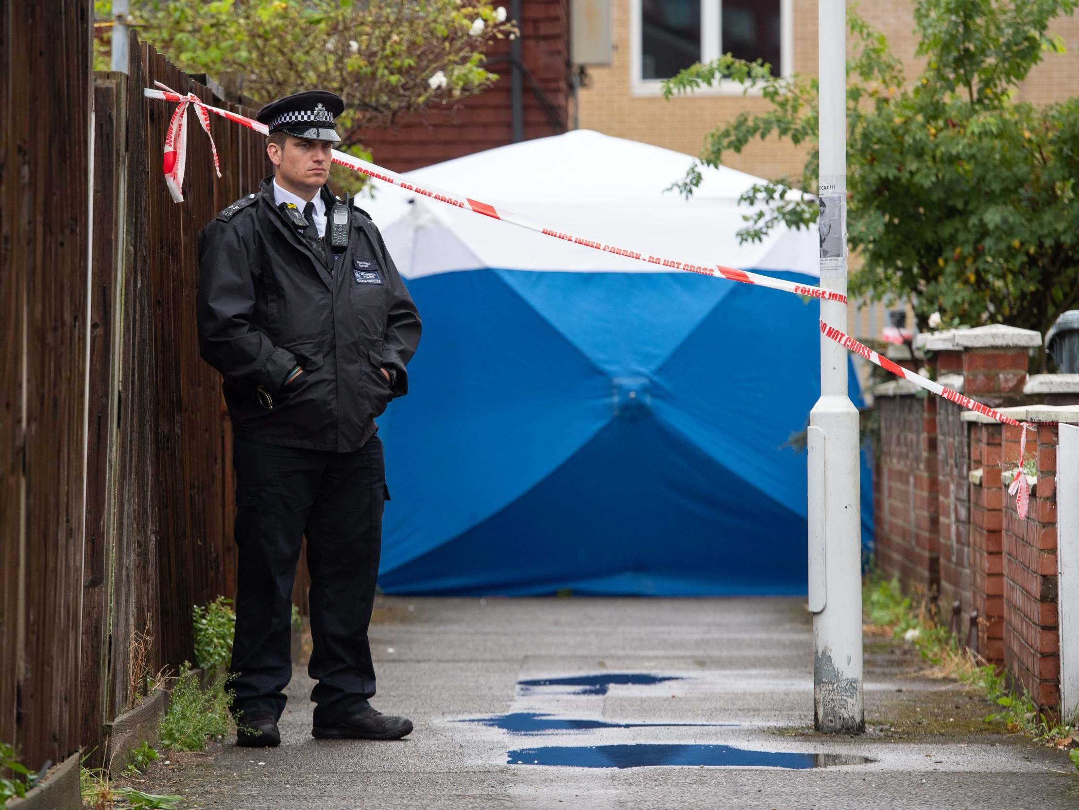 Police at the scene in Byford Close, Stratford, where detectives have launched a murder investigation