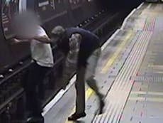 Man pushed on to Tube train tracks in attack caught on CCTV