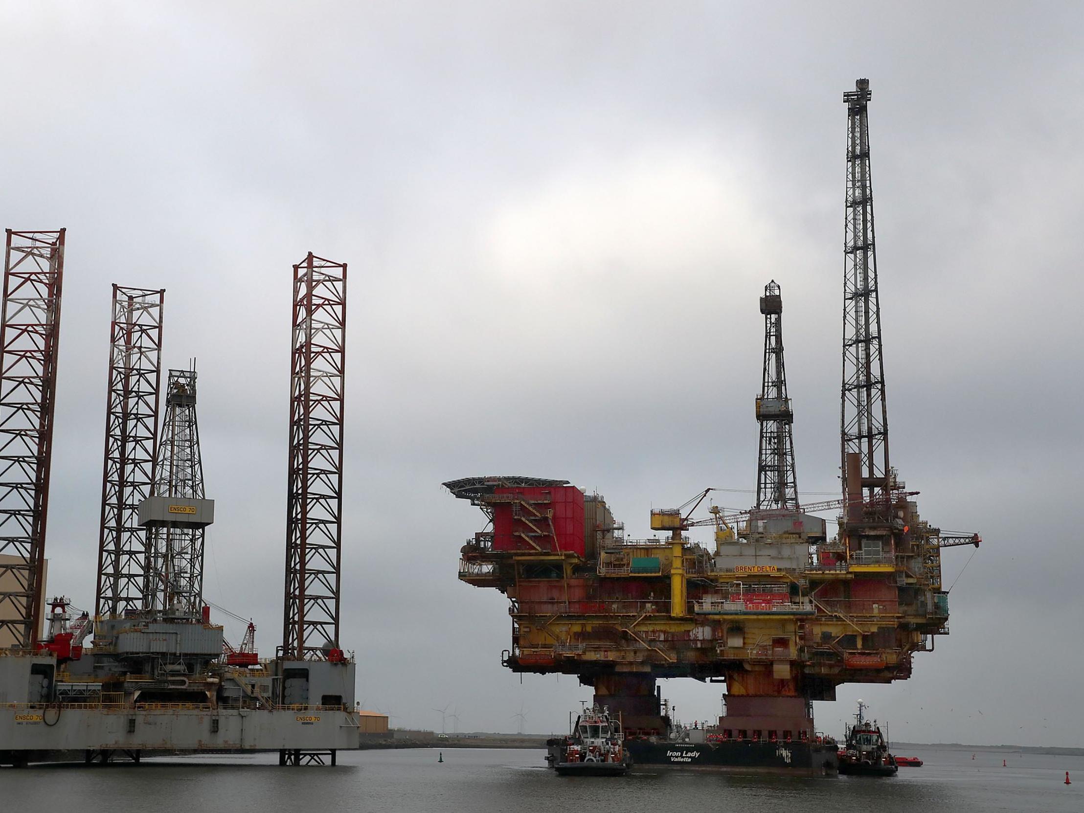 Shell's Brent Delta Topside offshore oil drilling rig platform is towed by tug boats up the River Tees to Able Seaton Port for decommissioning in England