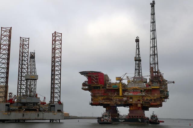Shell's Brent Delta Topside offshore oil drilling rig platform is towed by tug boats up the River Tees to Able Seaton Port for decommissioning in England