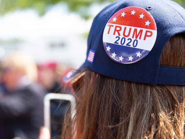 A woman prepares for a Trump rally in New Hampshire, which the president lost by less than half a point.