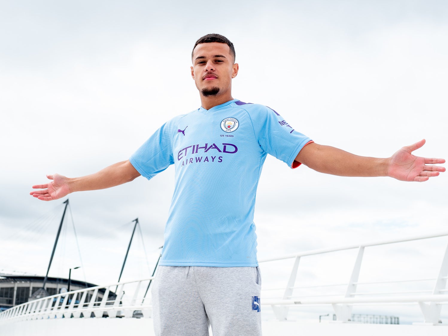 Joel Latibeaudiere poses outside the Etihad Stadium