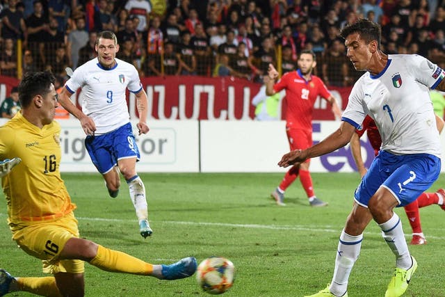 Italy's midfielder Lorenzo Pellegrini sees his shot saved