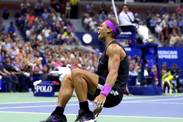 Rafael Nadal collapses to the floor after completing victory over Daniil Medvedev