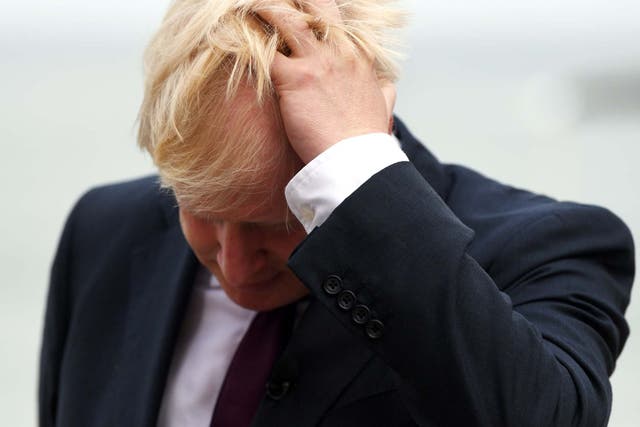 Boris Johnson reacts during a TV interview