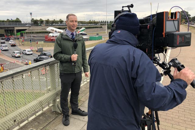 Quiet day: BBC reporter Simon Jones on location beside Heathrow's northern runway