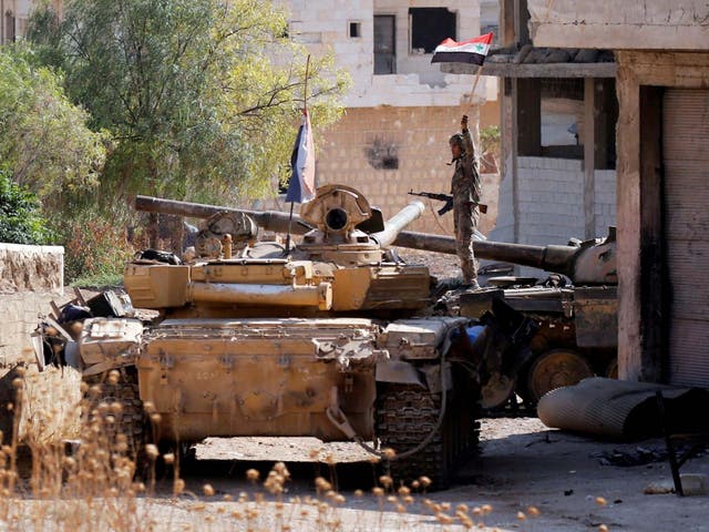 A Syrian army soldier atop a tank in Idlib