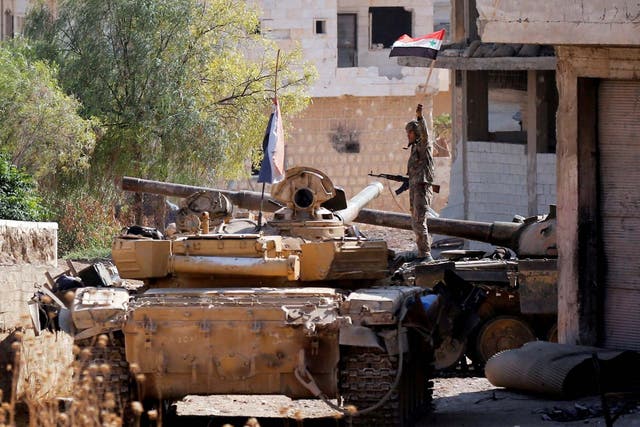 A Syrian army soldier atop a tank in Idlib