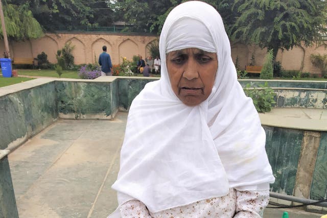 Mugli sits outside the prison where her son Rafiq is detained