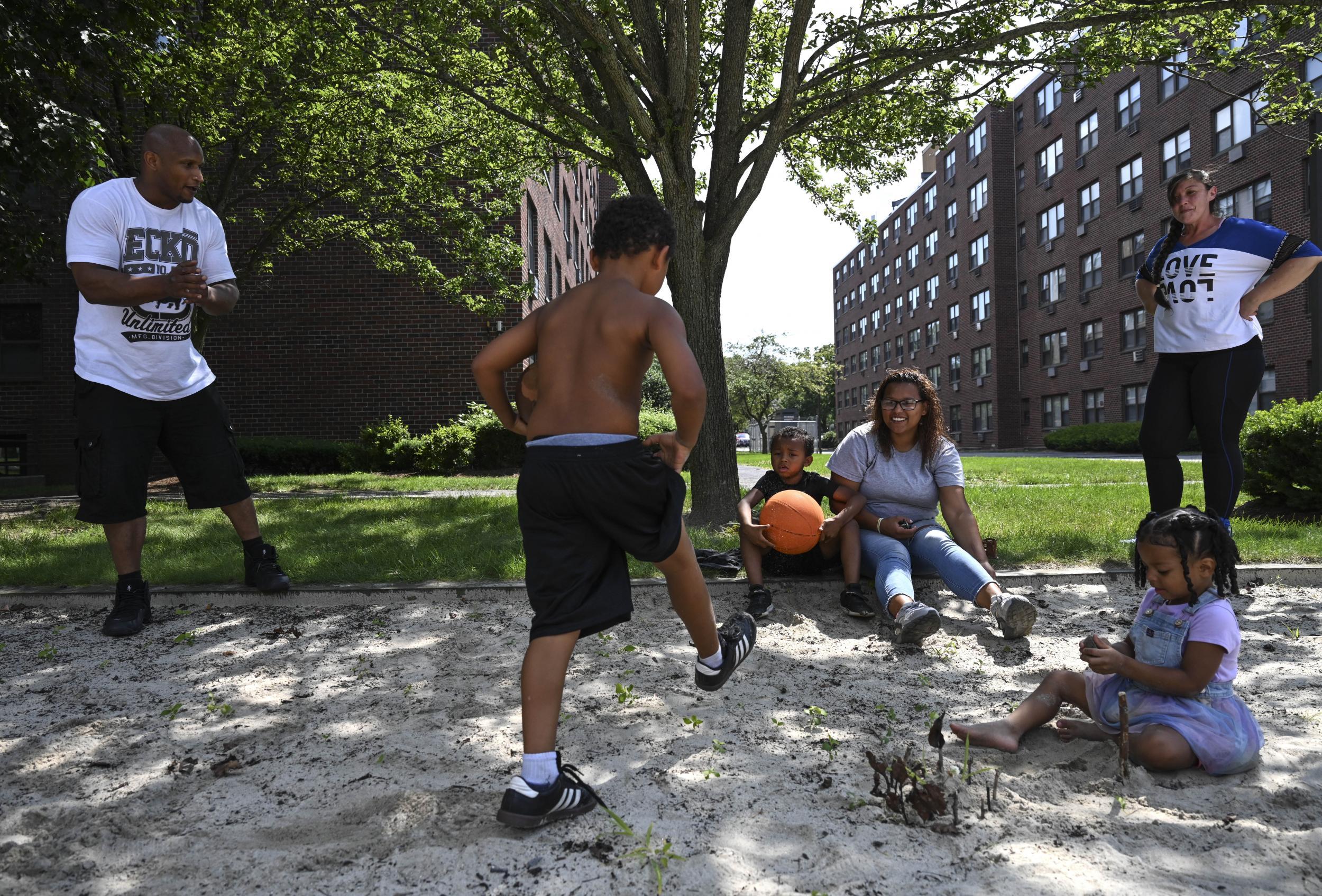 Lincoln and Heath (right) spend time with Lincoln’s daughter Janelle Hazard and her children at a playground in Hazard’s housing complex