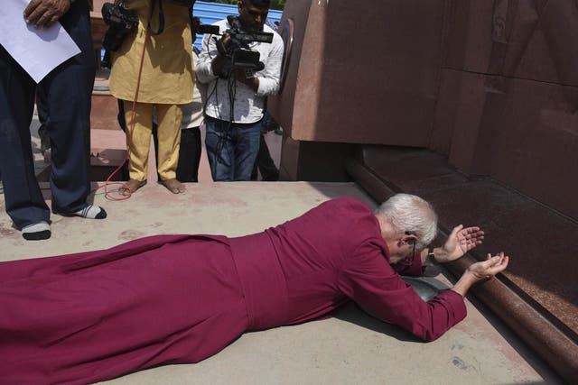 The Archbishop of Canterbury Justin Welby, prostrates as he pays respect at the Jallianwala Bagh memorial