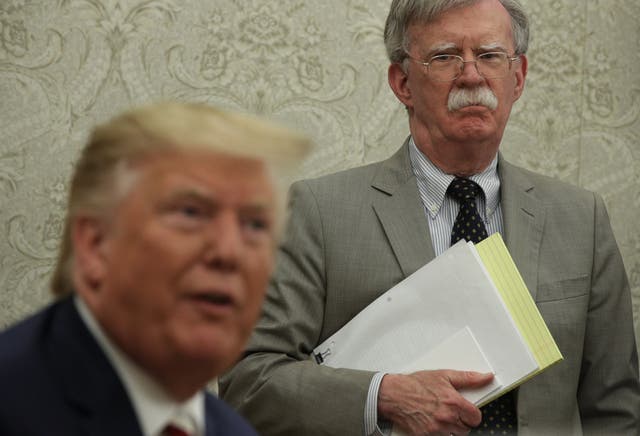 Former national security adviser John Bolton looks on as Donald Trump speaks at the White House. Getty Images