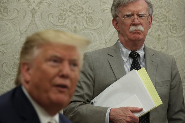 Former national security adviser John Bolton looks on as Donald Trump speaks at the White House. Getty Images