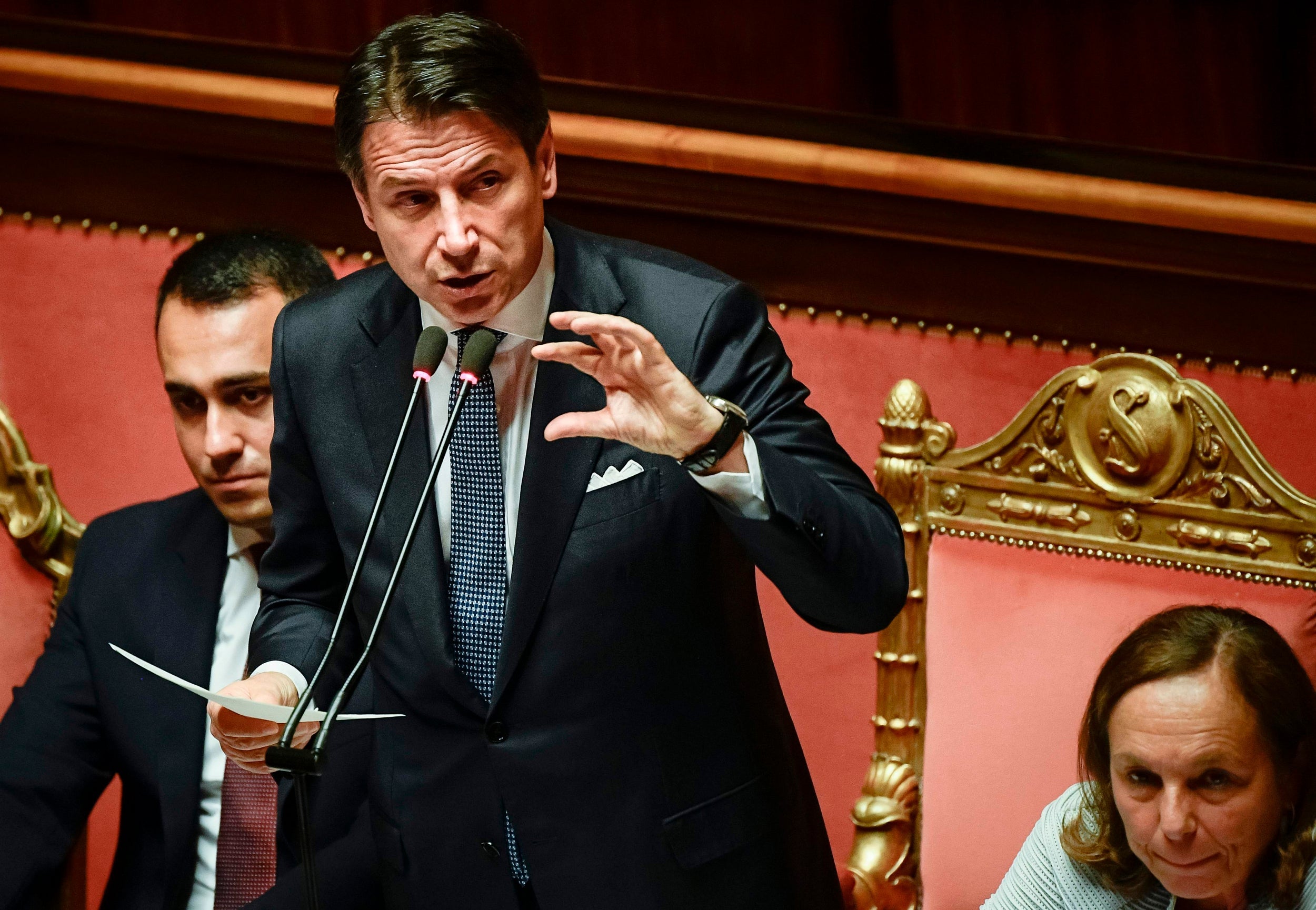 Italy's Prime Minister Giuseppe Conte (centre) delivers a speech as foreign minister Luigi Di Maio (left) and interior minister Luciana Lamorgese look on