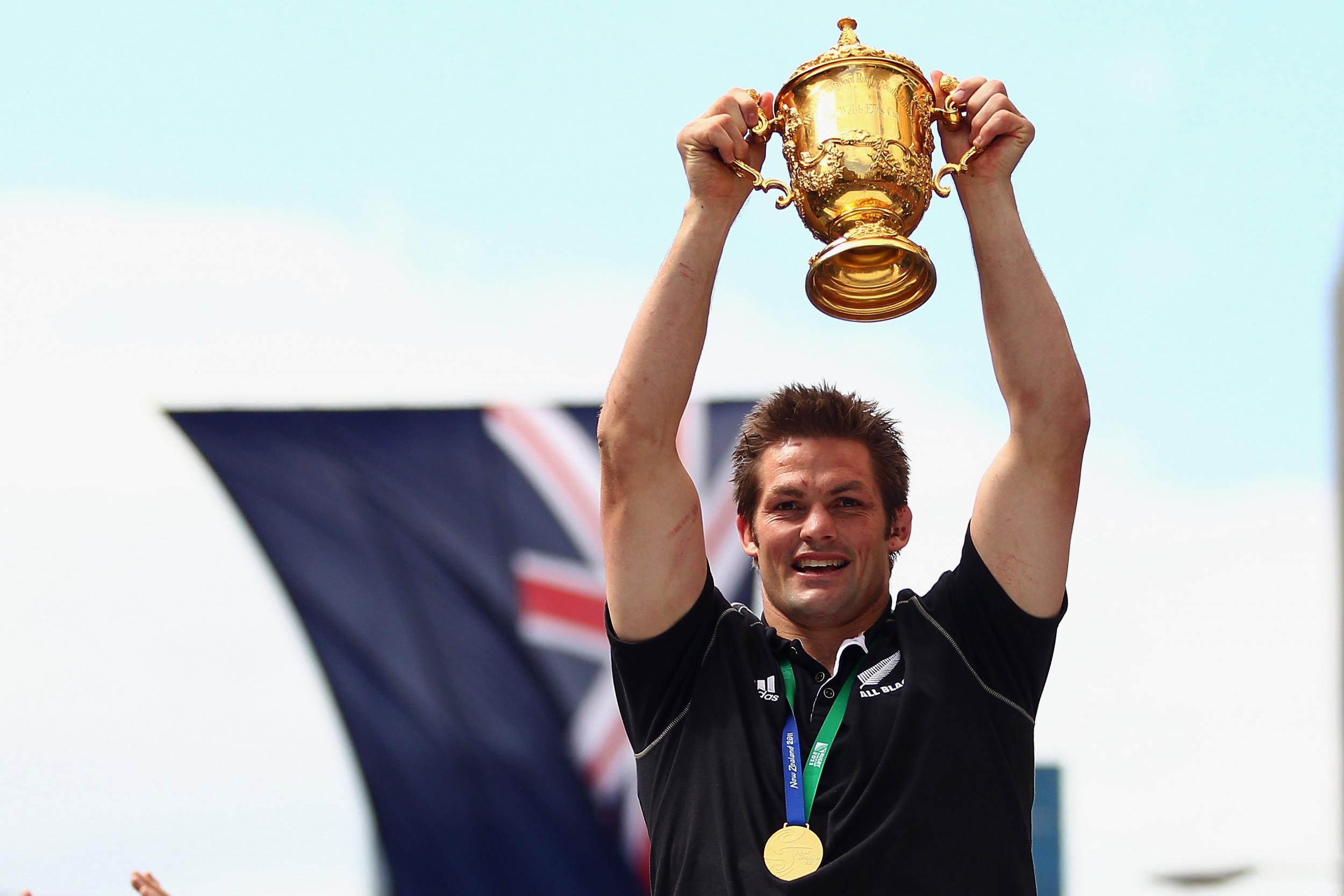 McCaw lifts the Webb Ellis Cup in Auckland on New Zealand's bus parade (Getty)