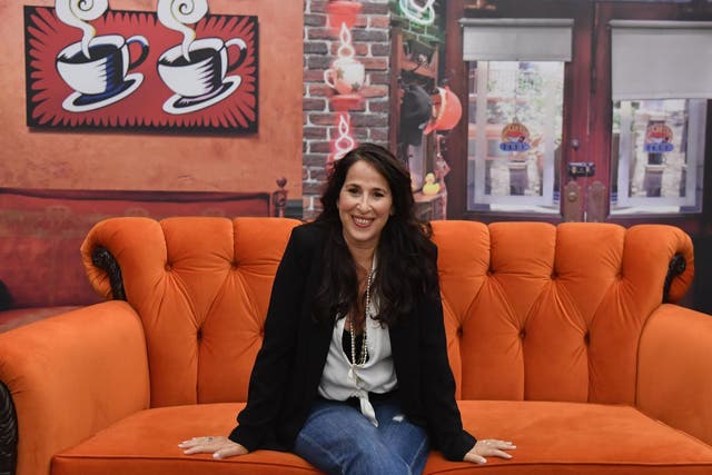 Maggie Wheeler, who played Janice on Friends, poses in a Central Perk replica during a press preview for pop-up exhibit marking the show's 25th anniversary on 5 September, 2019 in New York.