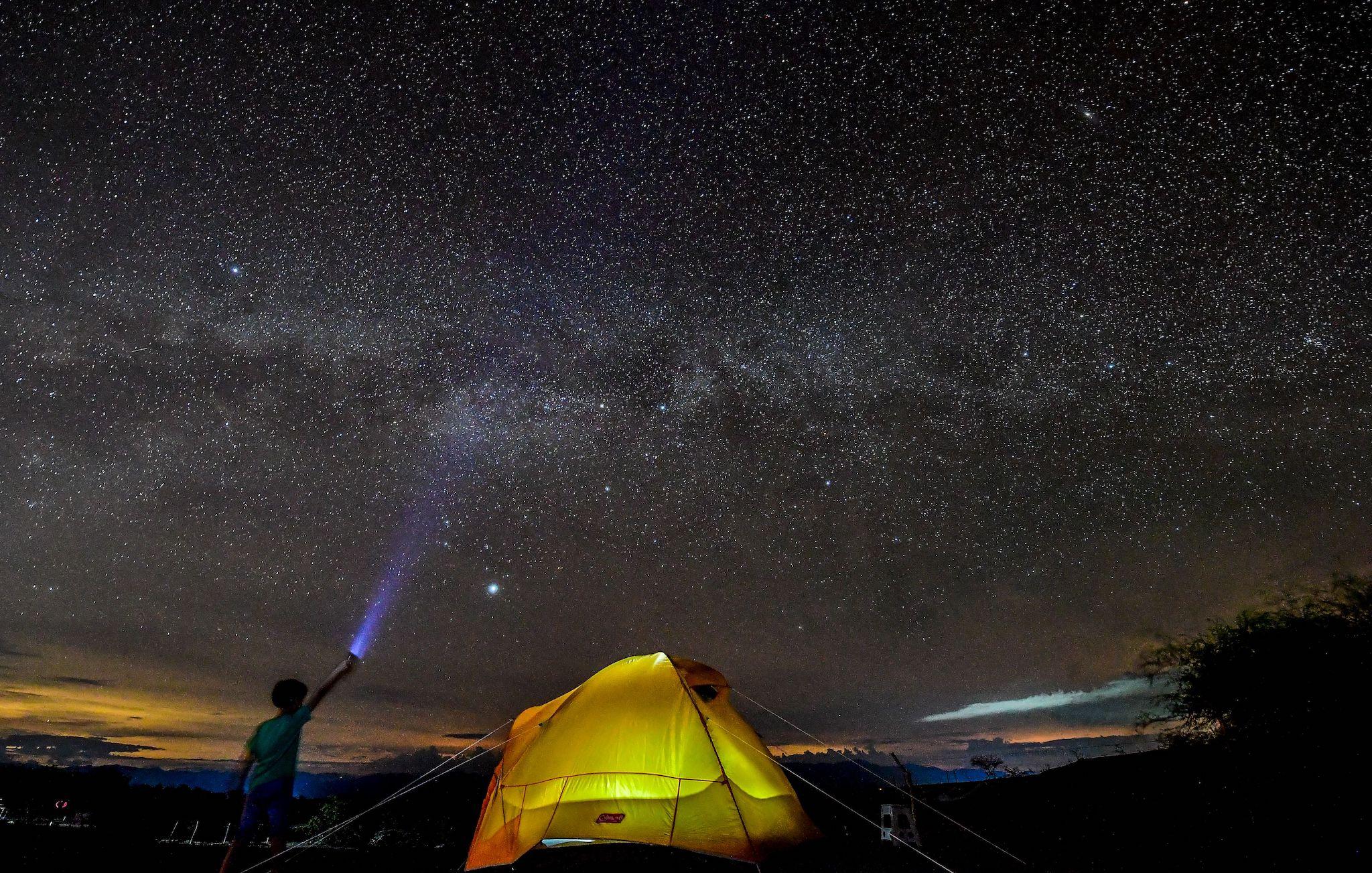 A boy watches the Milky Way in the sky over the Tatacoa Desert, in the department of Huila, Colombia, on October 11, 2018