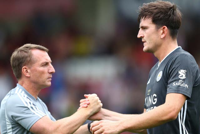 Harry Maguire shakes hands with Brendan Rodgers