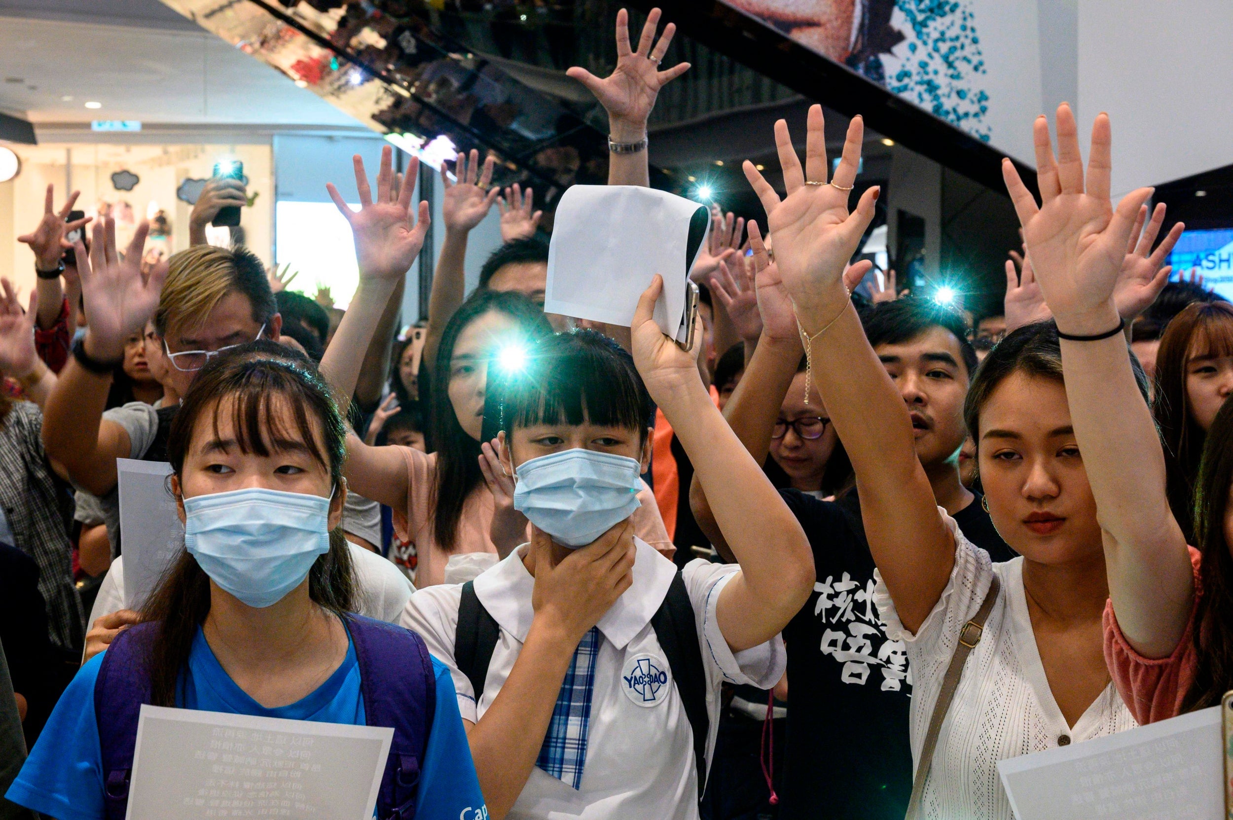 Pro-democracy demonstrators gather to sing songs and chant slogans during a rally at a shopping mall in Yuen Long