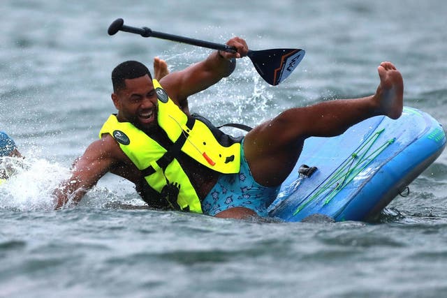 Joe Cokanasiga gets to grips with paddleboarding during England's training camp in Miyazaki