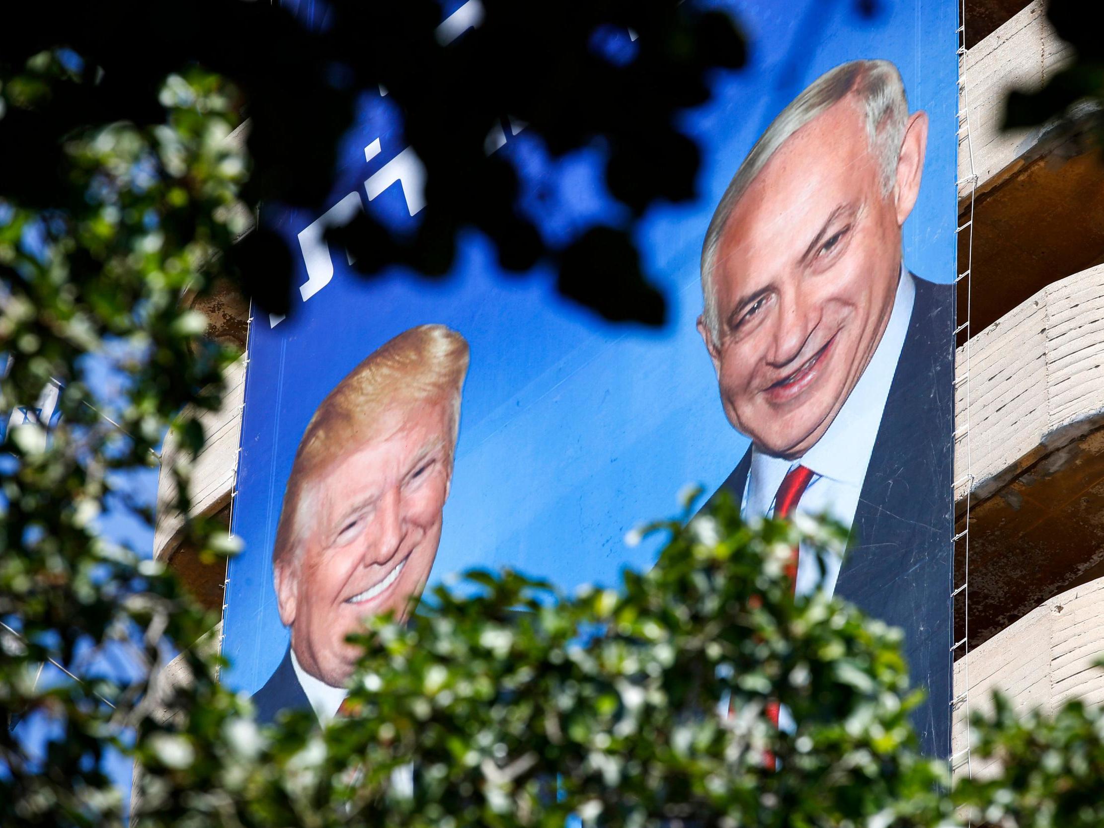 Two giant Israeli Likud Party election banners hanging from a building in Tel Aviv show Israeli Prime Minister Benjamin Netanyahu shaking hands with US President Donald Trump, 28 July 2019