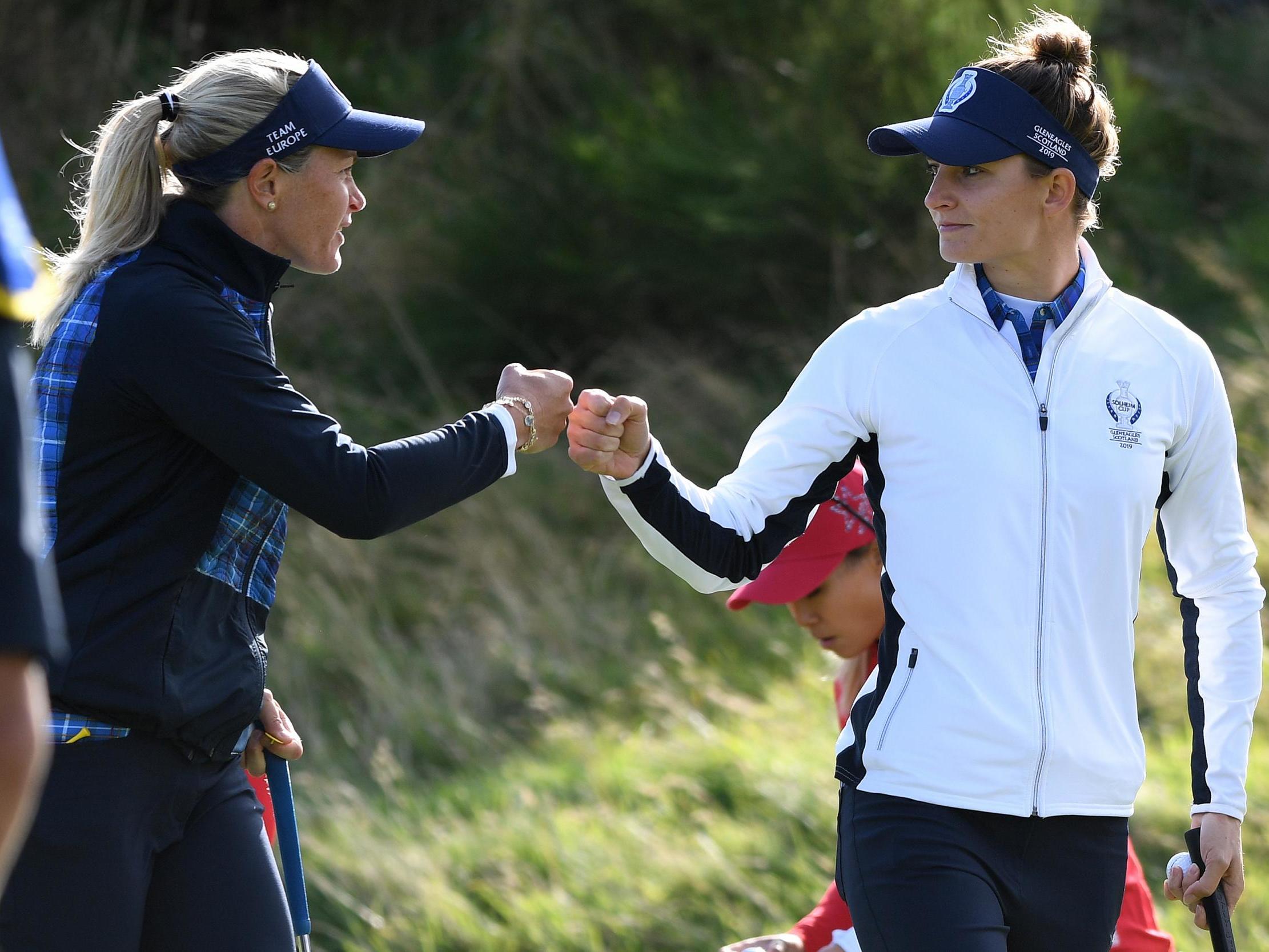 Suzann Pettersen and Anne Van Dam touch fists after holing a putt on the 7th green on the first day