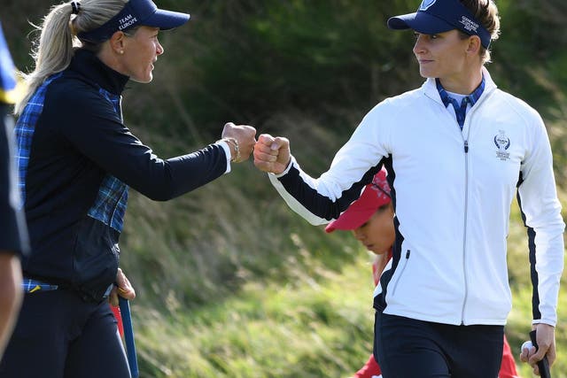 Suzann Pettersen and Anne Van Dam touch fists after holing a putt on the 7th green on the first day