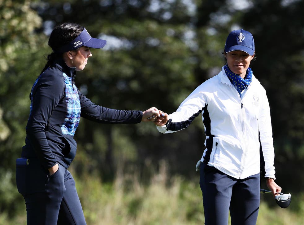 The two Europeans bump fists on the 15th green at Gleneagles