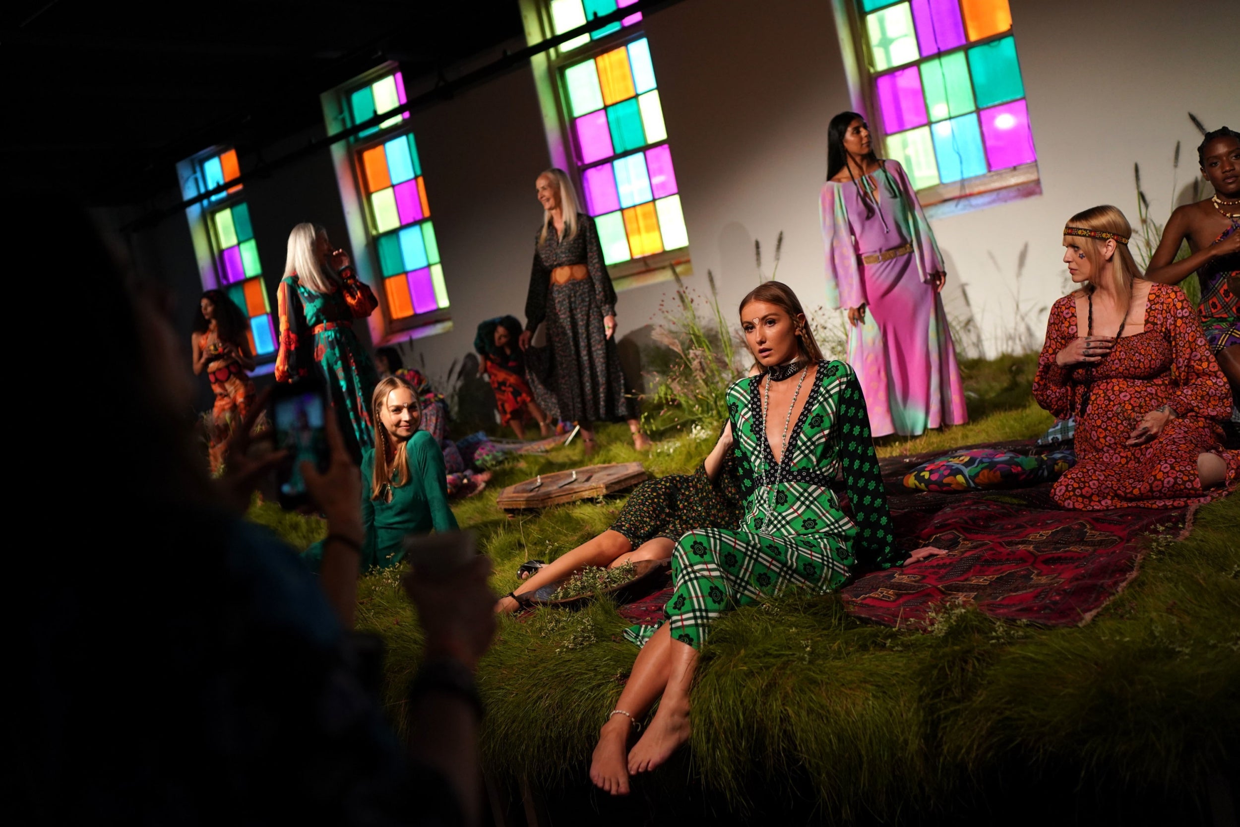 Models posed on a grass stage at the presentation of Rixo spring/summer 2020