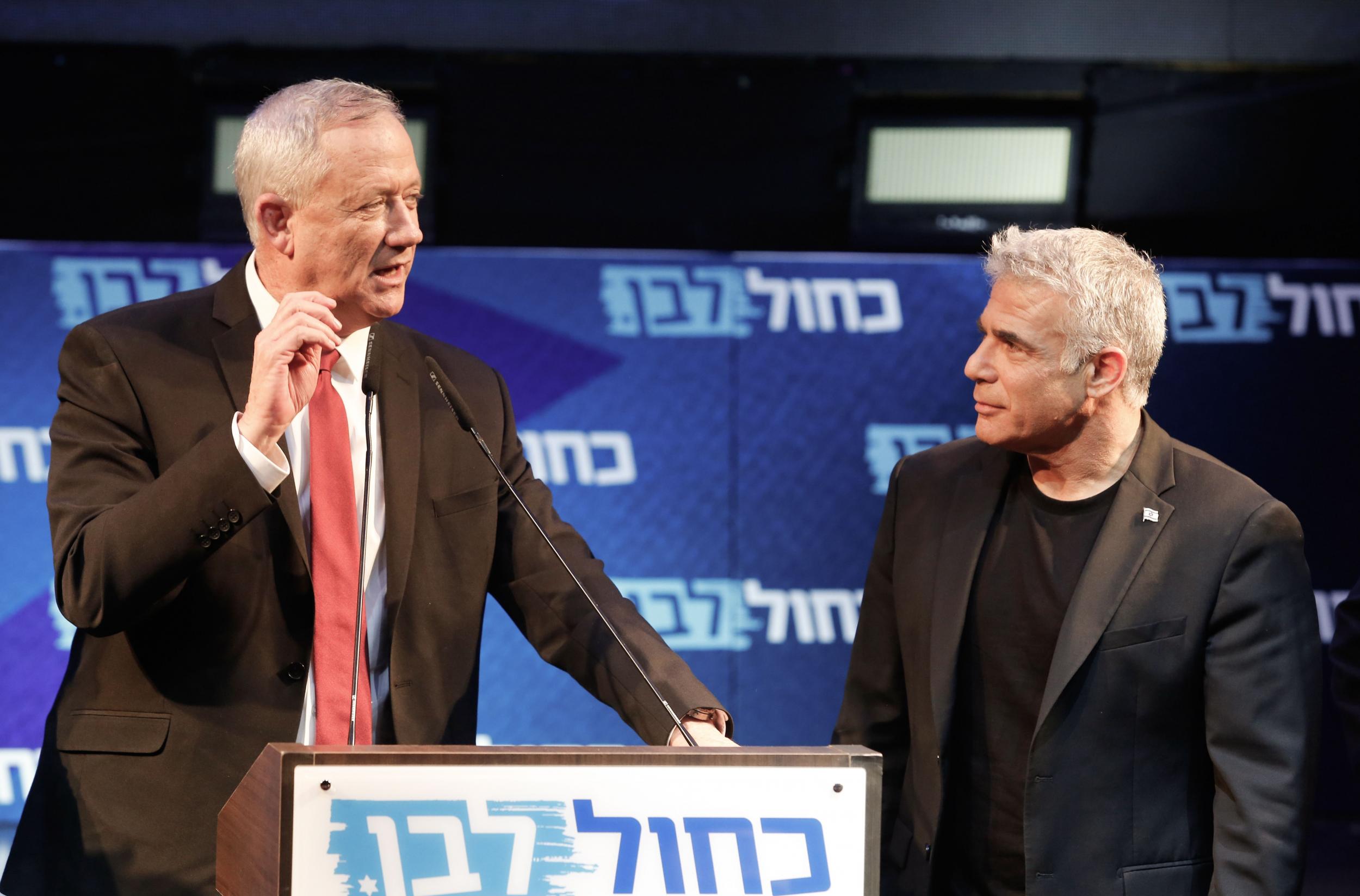 Benny Gantz (left) and Yair Lapid, the leaders of the Blue and White electoral alliance, attend a campaign event (AFP/Getty)