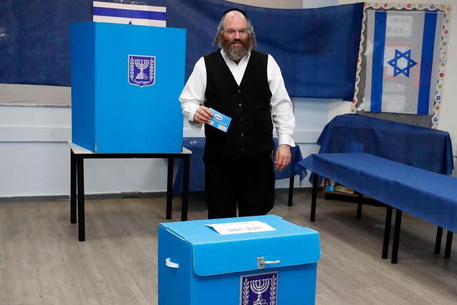 An ultra Orthodox Jewish man casts his ballot during Israel's parliamentary election, at a polling station in Rosh Haayin