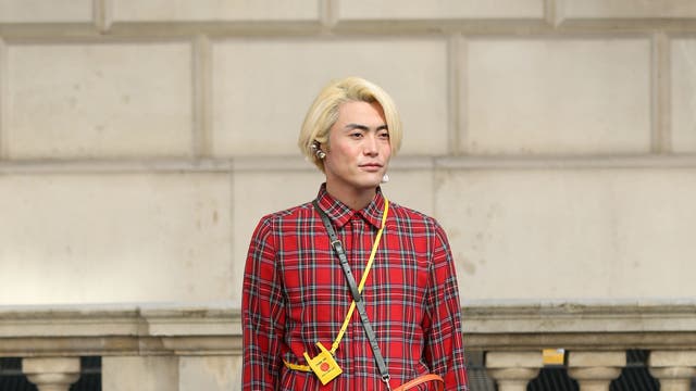 The popularity of plaid shows no signs of abating. This fashion week guest accessorised his bright scarlet ensemble with black loafers, camel-coloured socks and a tangerine shoulder bag.