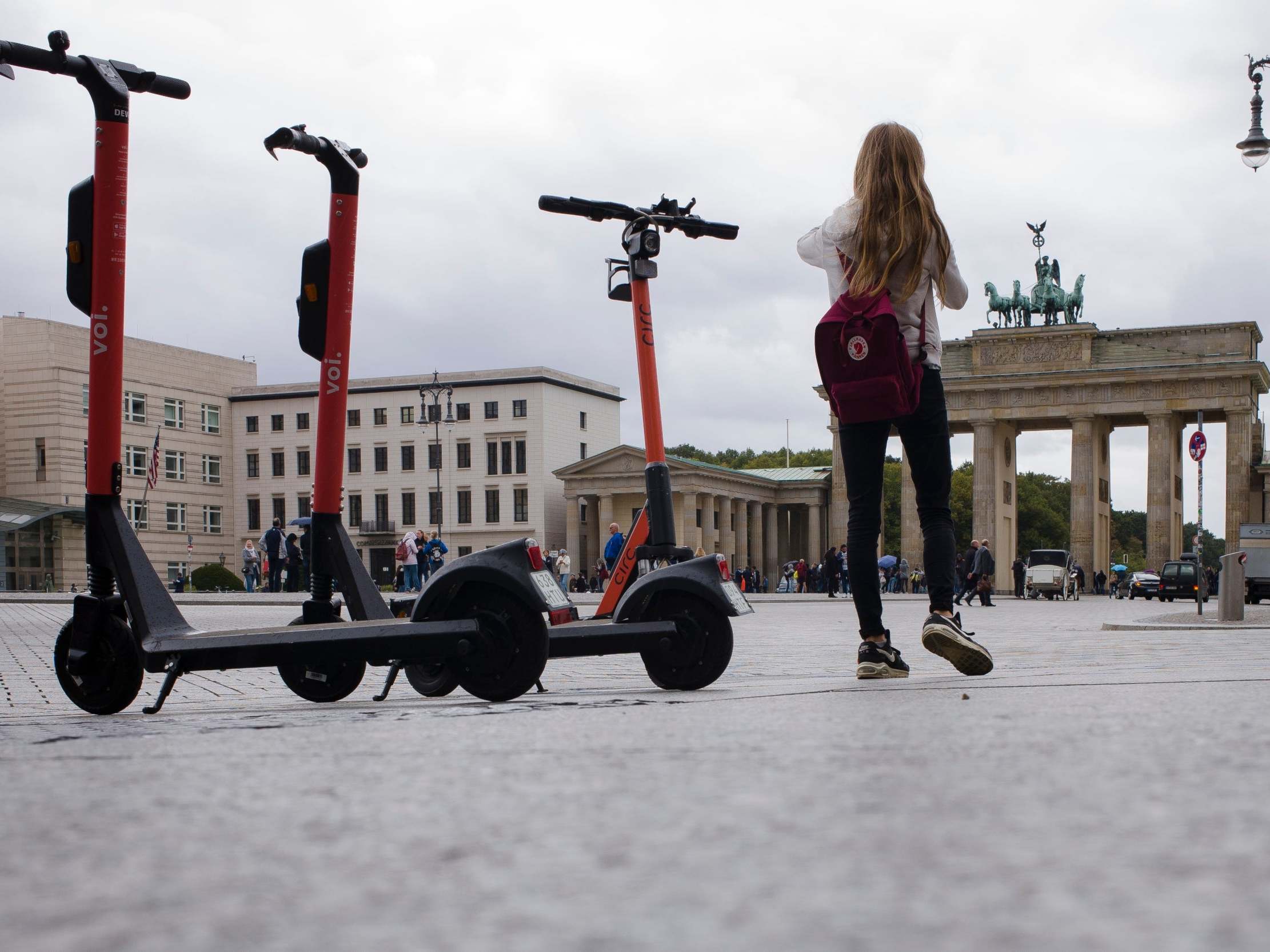 Electric scooters stand in front of the Brandenburg Gate in Berlin, Germany, 17 September, 2019.
