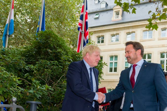 Boris Johnson and Xavier Bettel shake hands before their meeting in Luxembourg