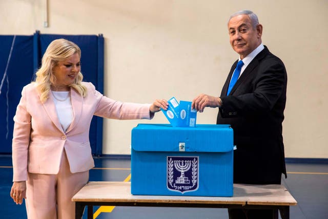 Israeli Prime Minister Benjamin Netanyahu and his wife Sara casts their votes at a voting station in Jerusalem