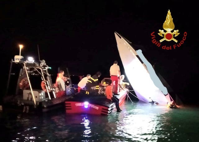 Rescue workers surround the remains of a speed boat which crashed in Venice, Italy